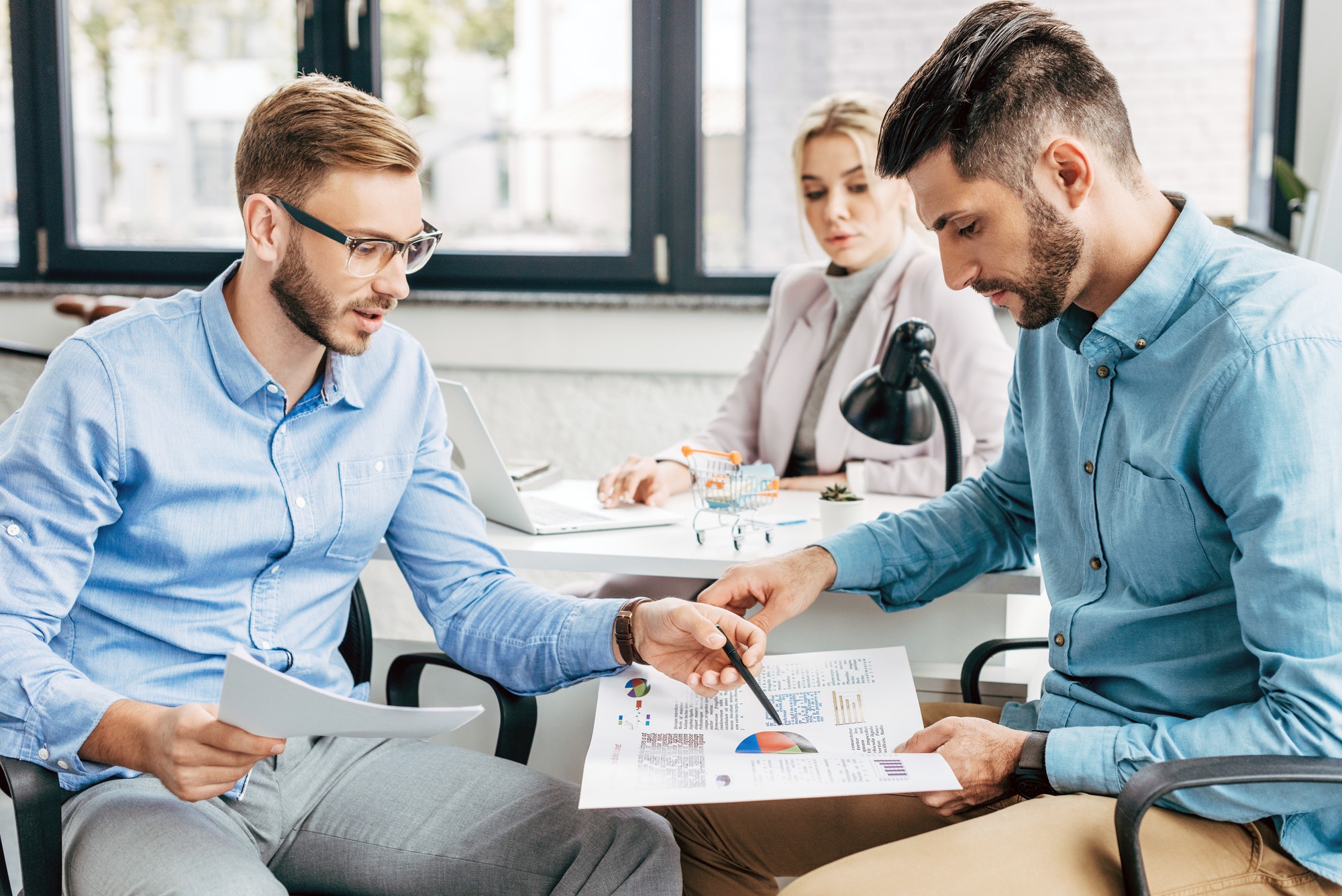 young-start-up-team-discussing-business-charts-in-office.jpg